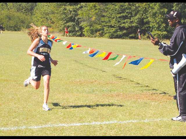 Carlson, Lady Cats win Region 3AAA cross country titles