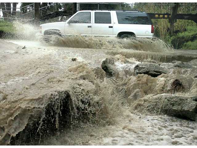 Making waves: Cars slip, slide in storm