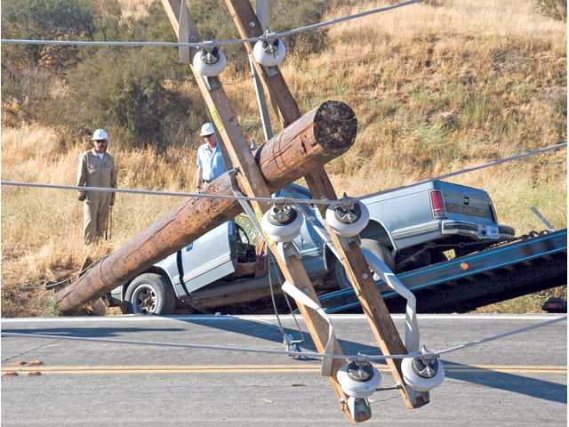 Truck knocks down power pole