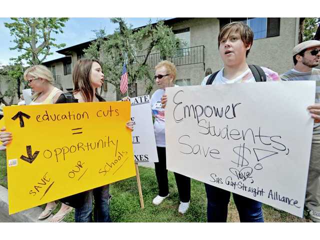 Groups protest governor's visit