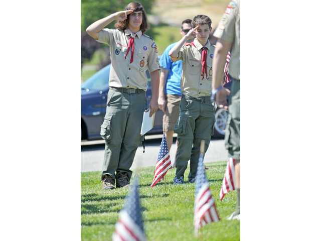 Boy Scouts and Girl Scouts place flags at Eternal Valley