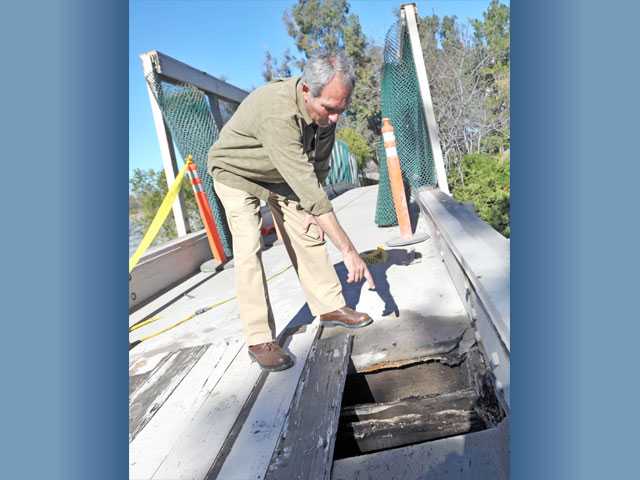 Construction crew tears down paseo bridge