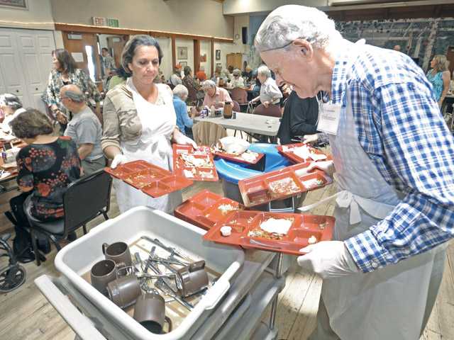 Volunteer kitchen staff at Senior Center serves food, takes pride in helping out the co