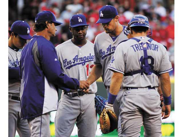L.A. loses 6-0 to Reds, falls back in race 