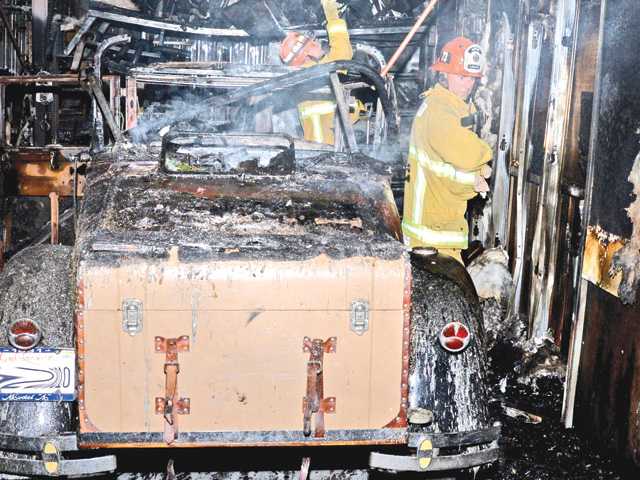 Garage fire burns car in Newhall