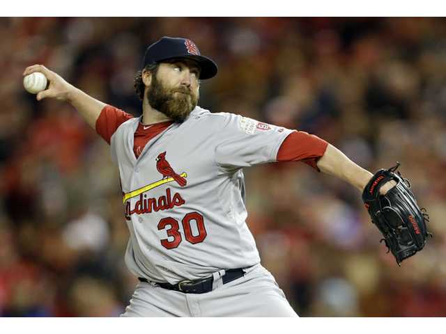 Cards score 4 in 9th, beat Nats 9-7, reach NLCS 