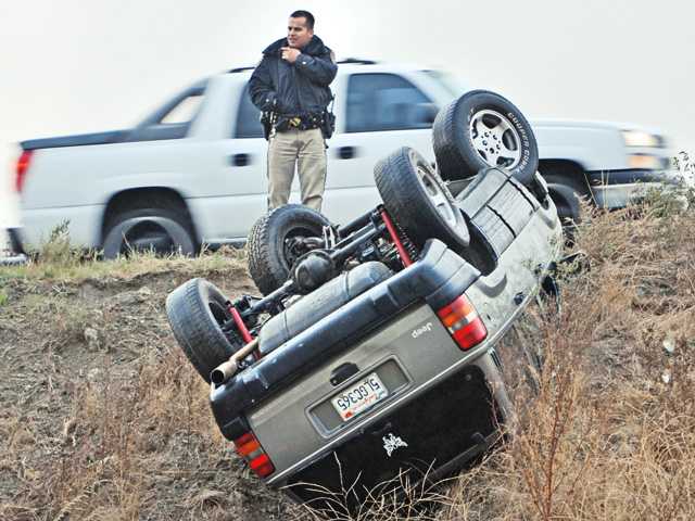 SUV rolls on drizzly afternoon