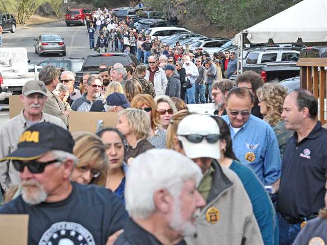 Hundreds of attendees line up to purchase an autographed copy of Sarah Palin's "Sweet Freedom: A Devotional" during a book signing event Saturday at Oaktree Gun Club in Newhall.