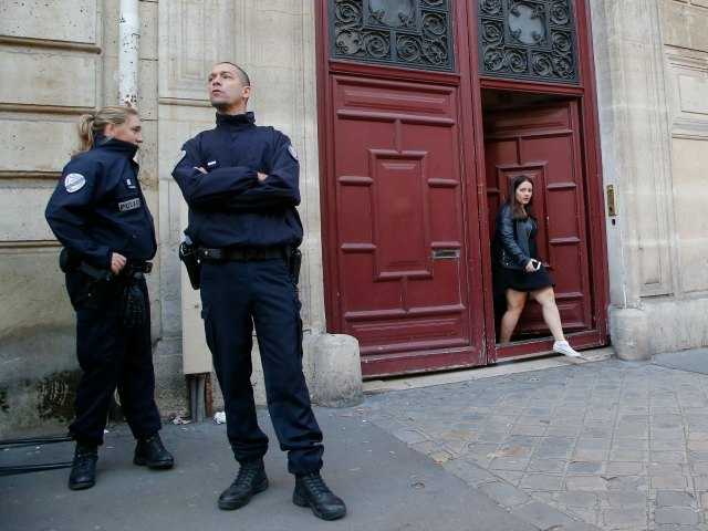 <p>French police officers stand outside the residence of Kim Kardashian West in Paris Monday, Oct. 3, 2016.</p>