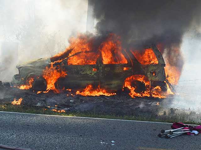 Woman pulled from burning SUV Woman pulled from burning SUV