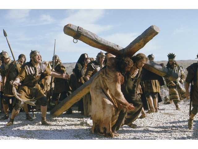 simon of cyrene, right, help actor jim caviezel, portraying